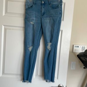 Distressed light blue jeans